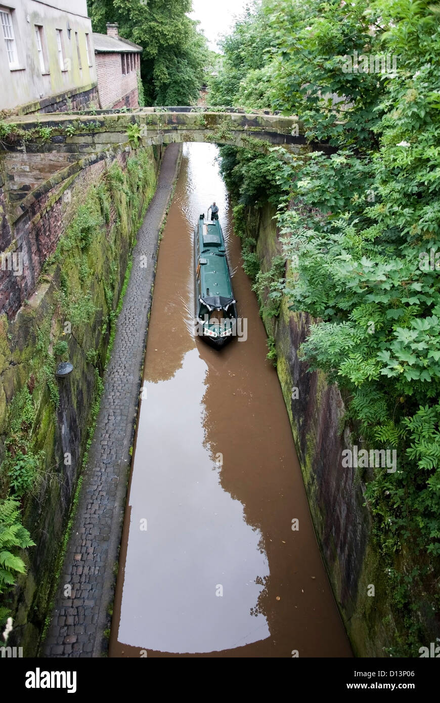 Green Narrowboat Chalico navigating the Shropshire Union Canal Stock Photo