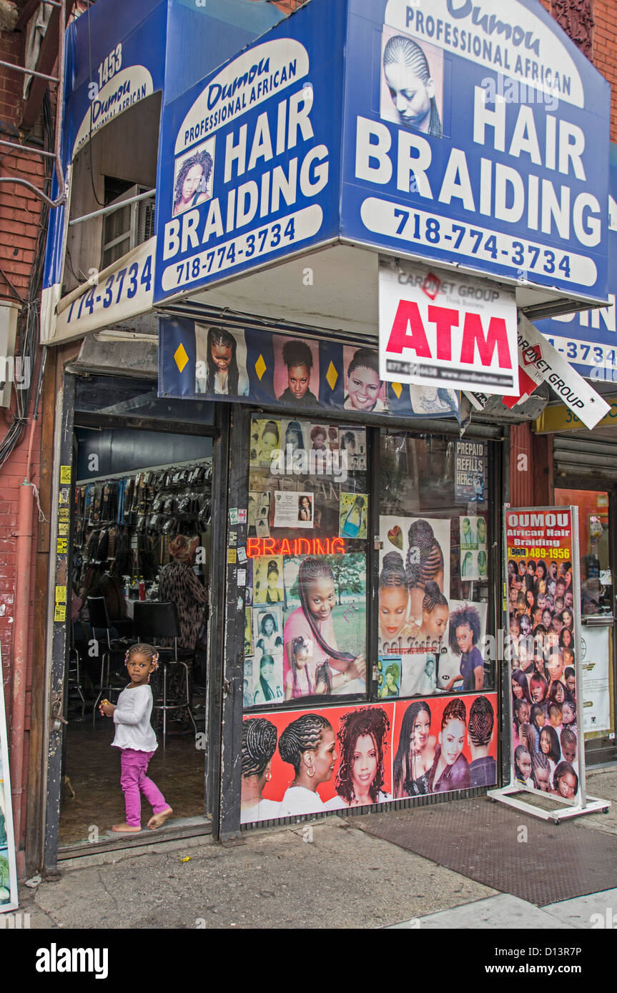 Little girl with Rasta hairs in front of Braiding Shop, Crown Heights , Brooklyn, New York Stock Photo