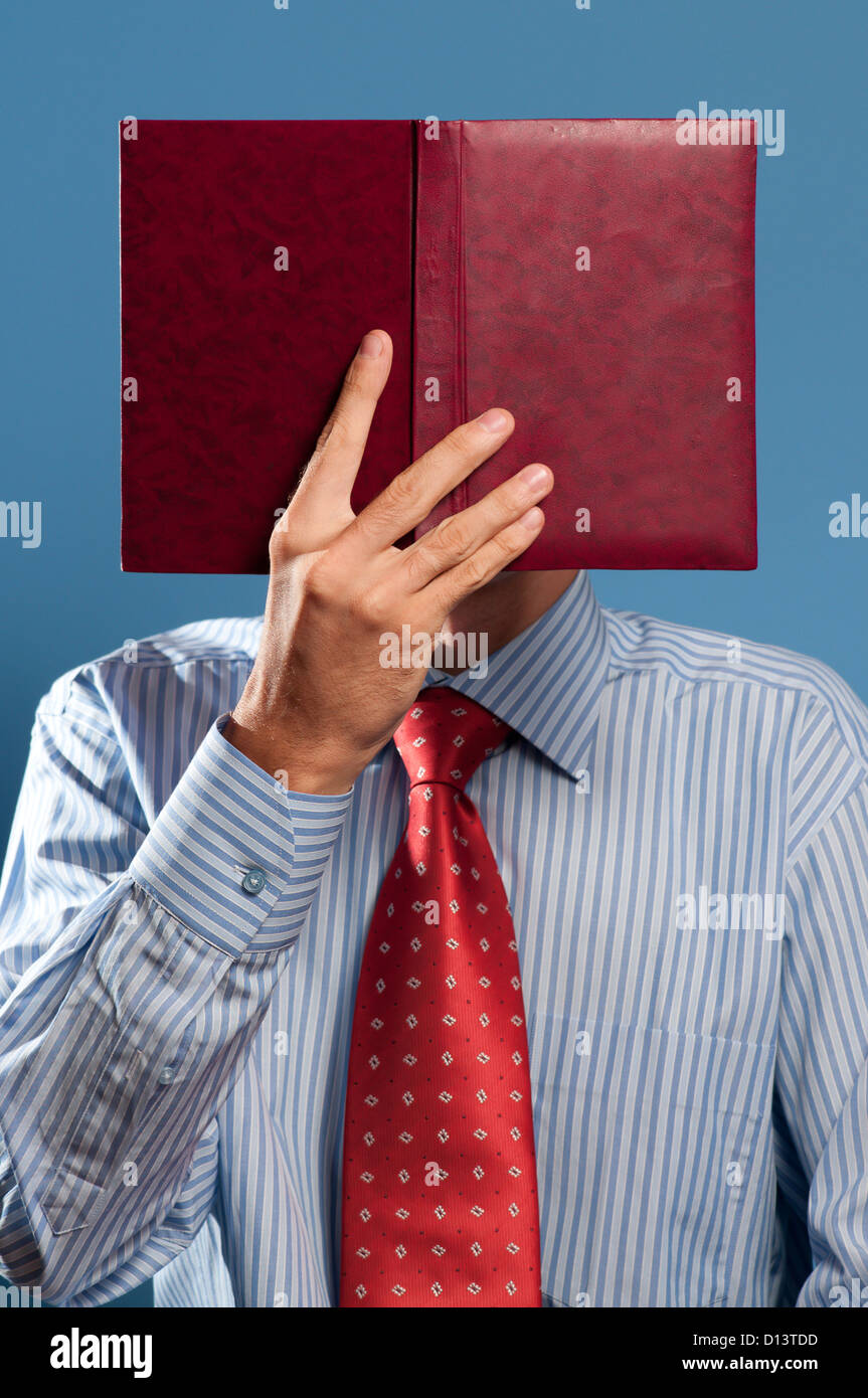 man with red open book in front of his head Stock Photo