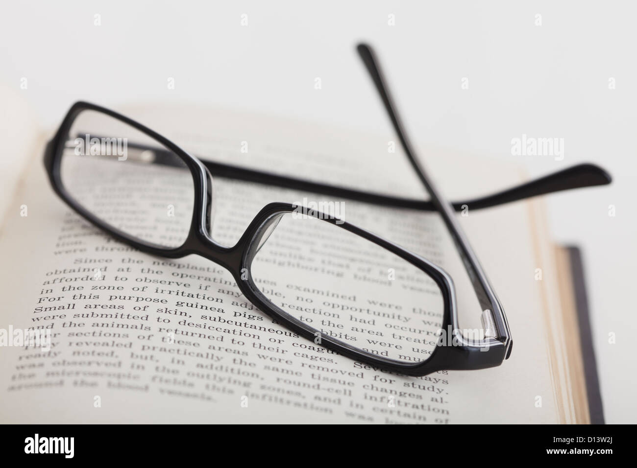Close up of reading glasses on book, studio shot Stock Photo