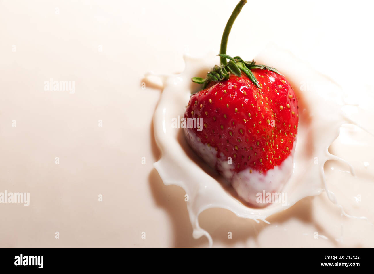 strawberry dropped in yogurt Stock Photo