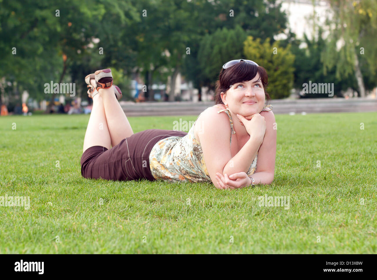 Beautiful woman lying on green grass Stock Photo - Alamy