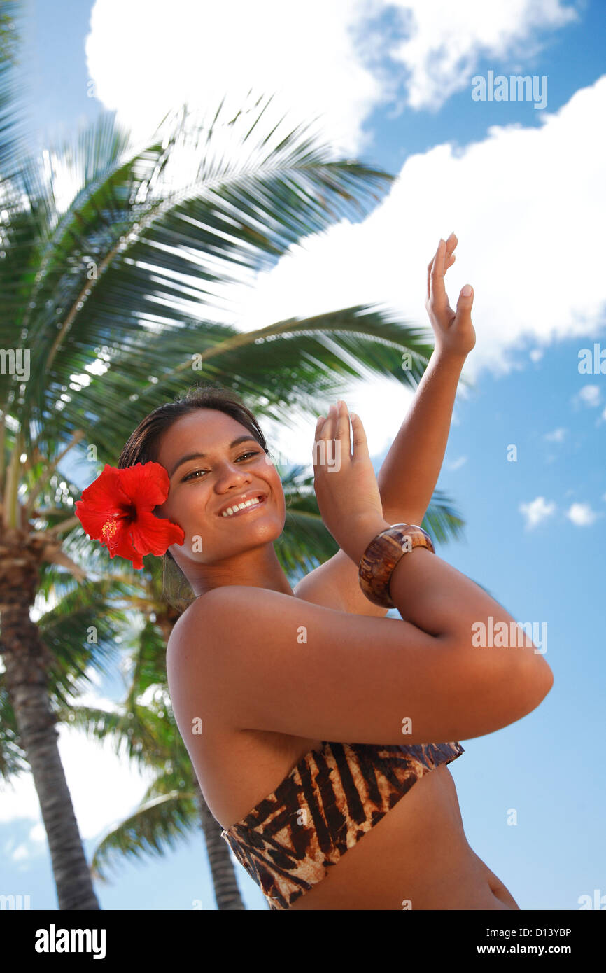 Female Hawaiian Hula dancer wearing coconut bikini, yellow lei