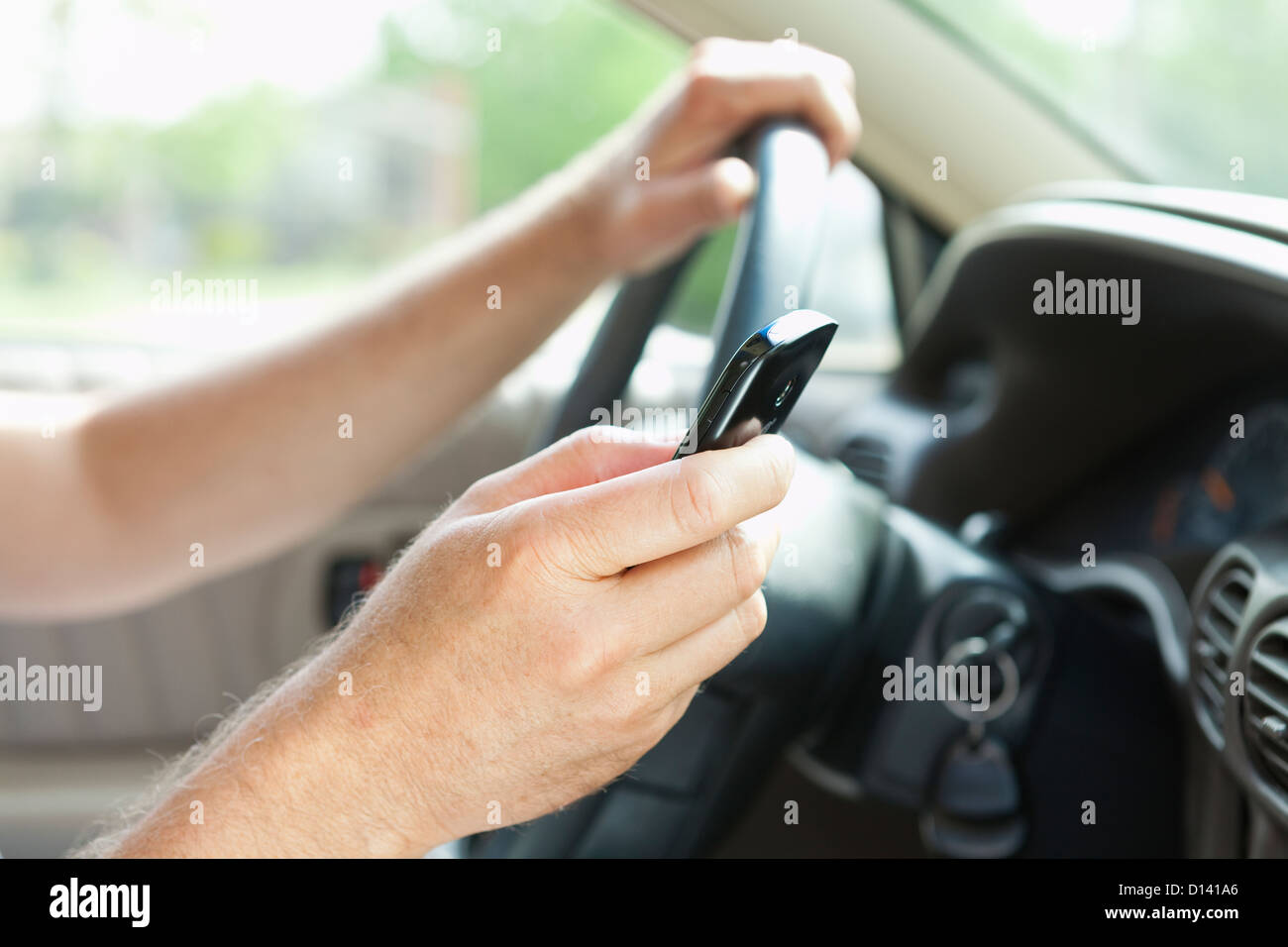 USA, Illinois, Metamora, Man texting on his mobile in car Stock Photo