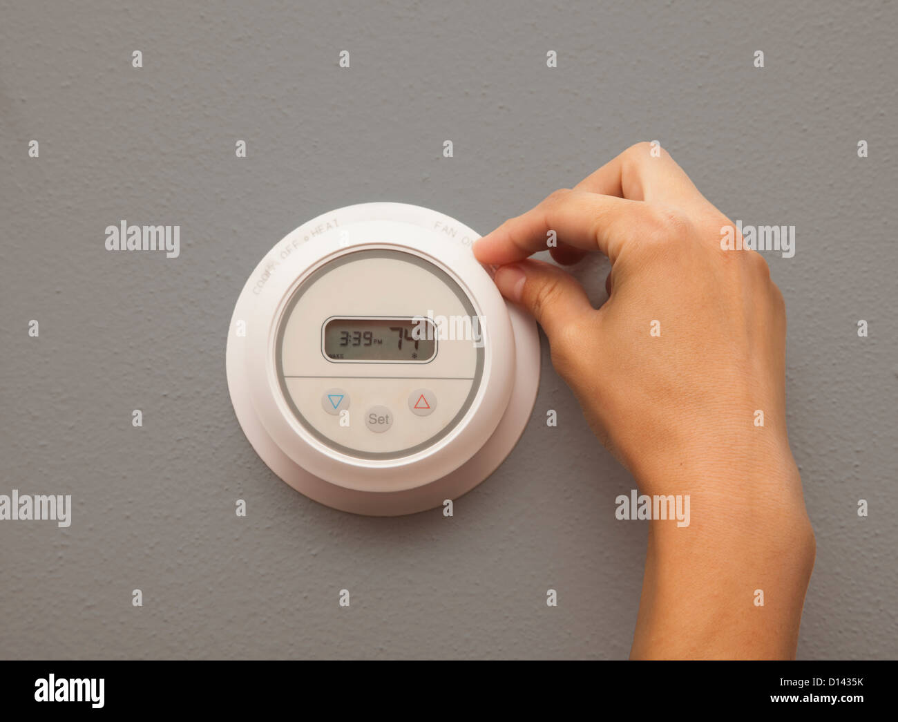 USA, Illinois, Metamora, close-up of woman adjusting thermostat Stock Photo