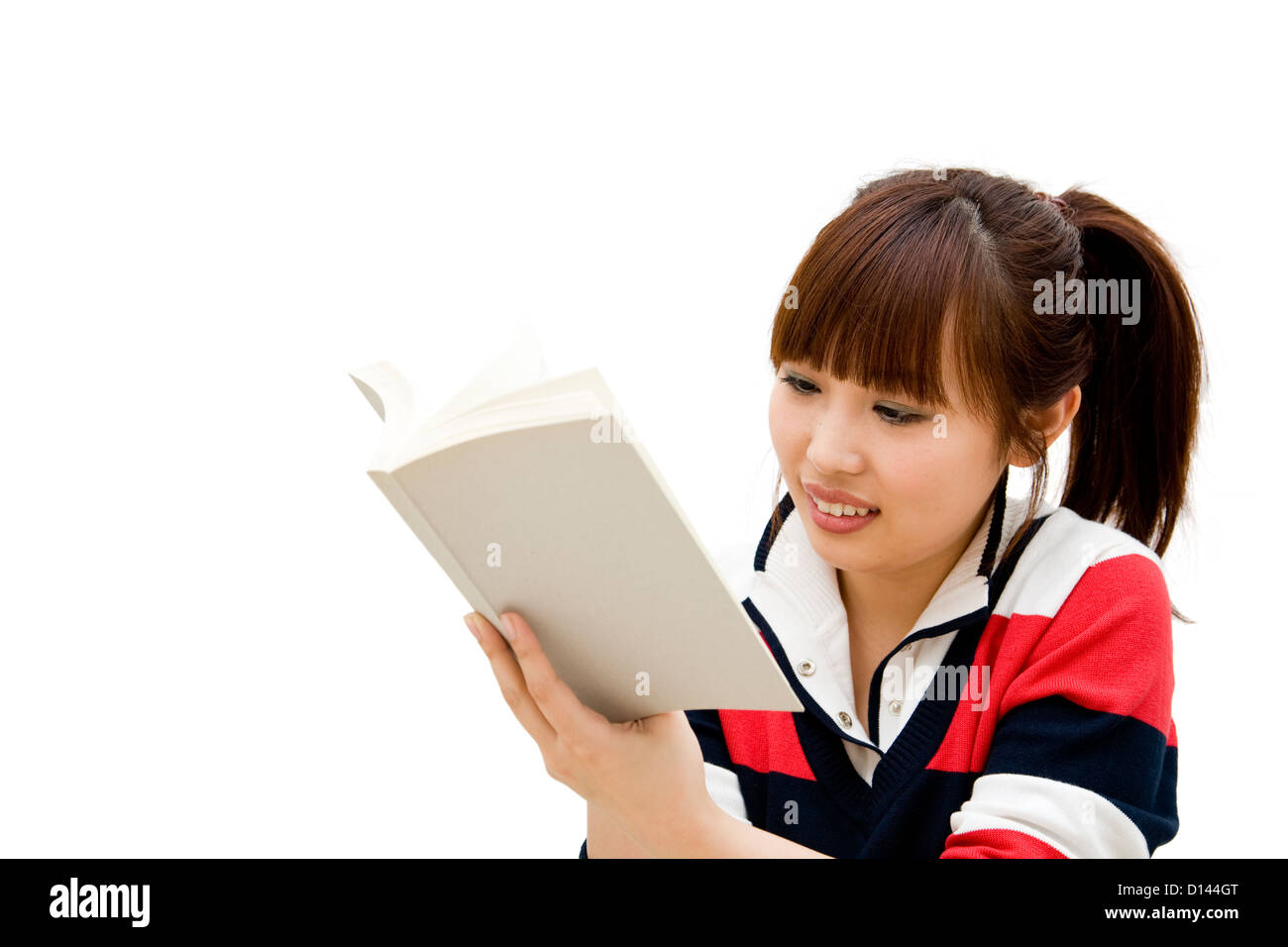 Girl reading book, isolated on white. Stock Photo