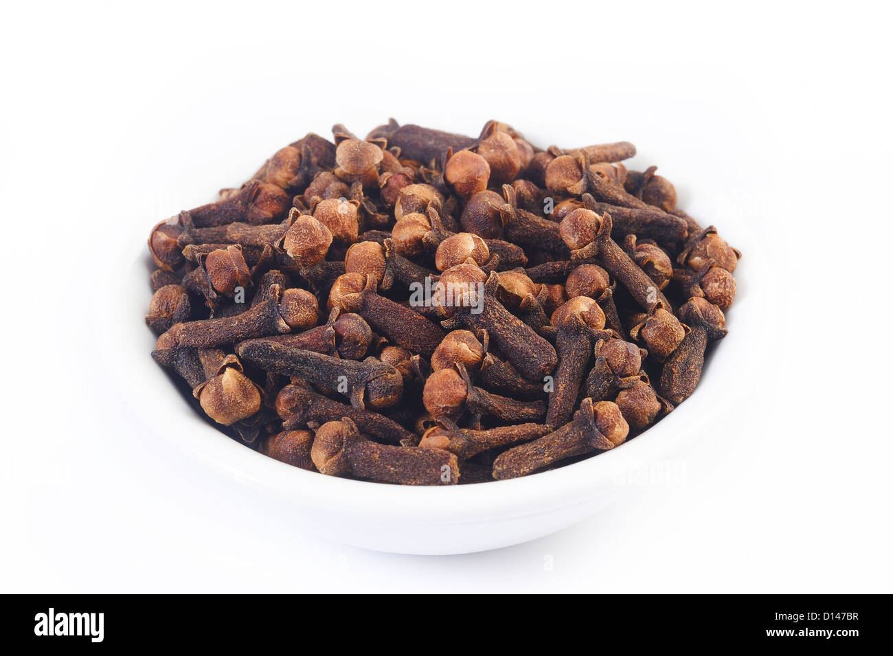 cloves in white dish on white background Stock Photo