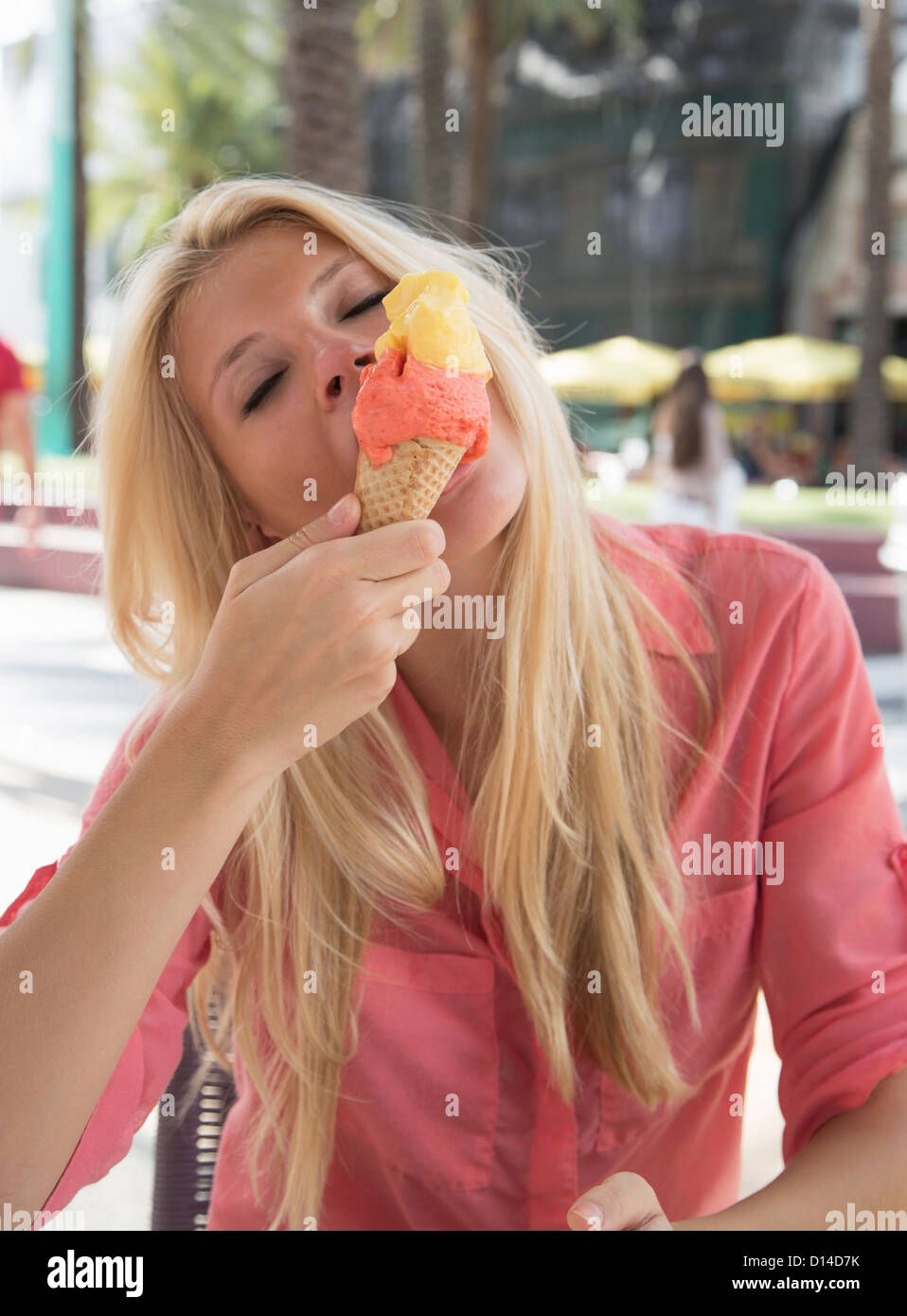 Woman eating ice cream cone outdoors Stock Photo