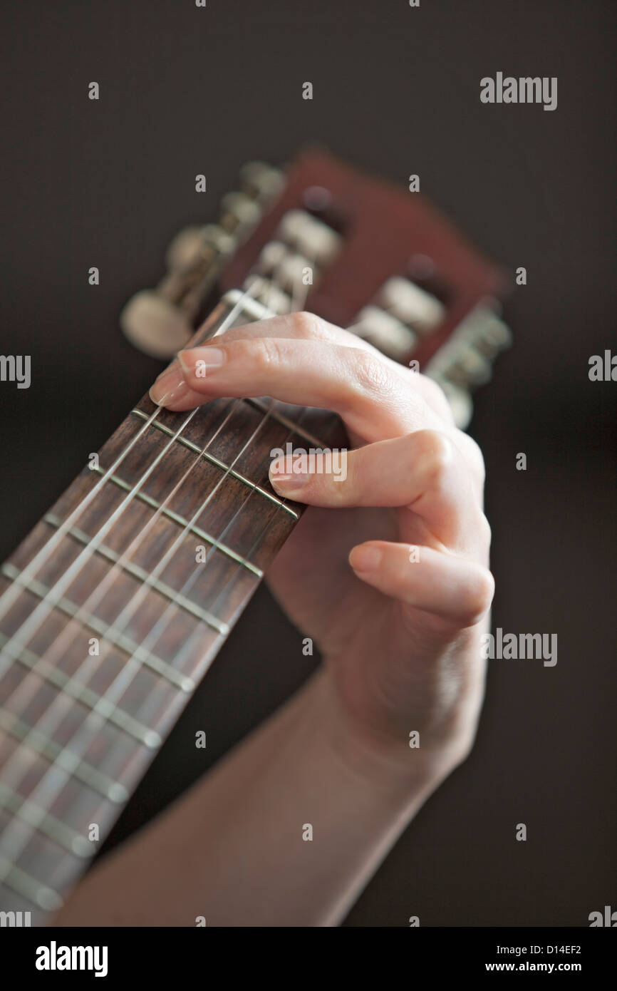 close-up of young woman playing guitar Stock Photo