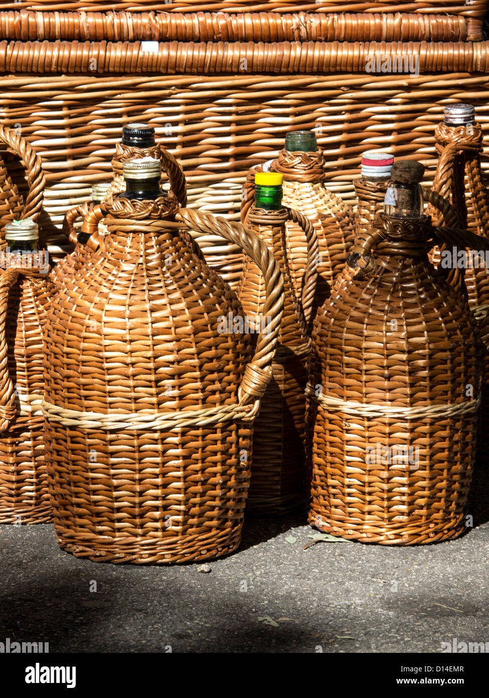 glass bottles protected with cane Stock Photo