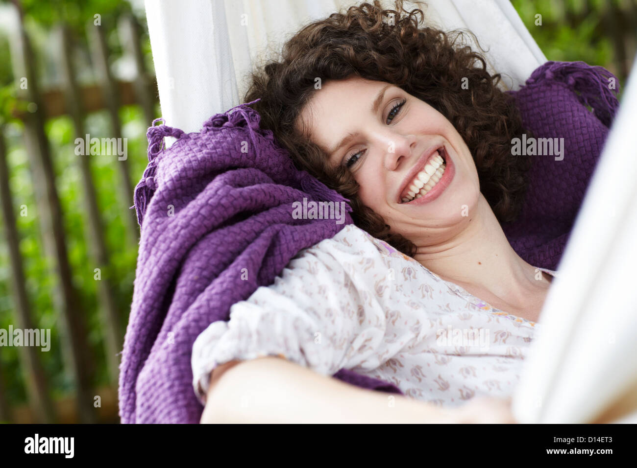 young woman lying in hammock in the garden Stock Photo