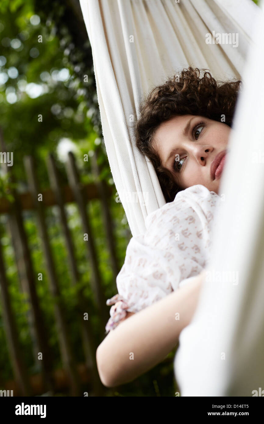 young woman lying in hammock in the garden Stock Photo