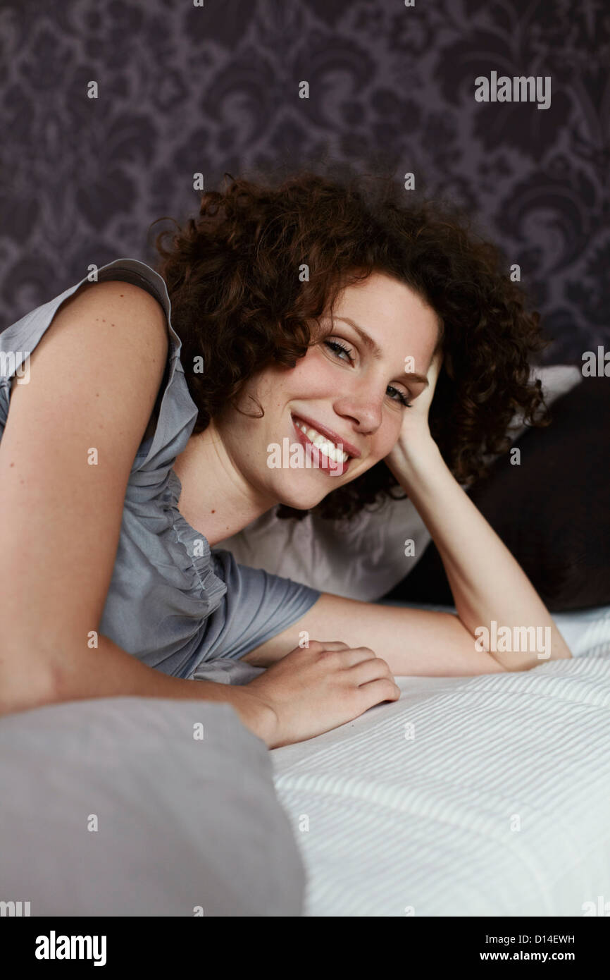 portrait of young woman in bed Stock Photo