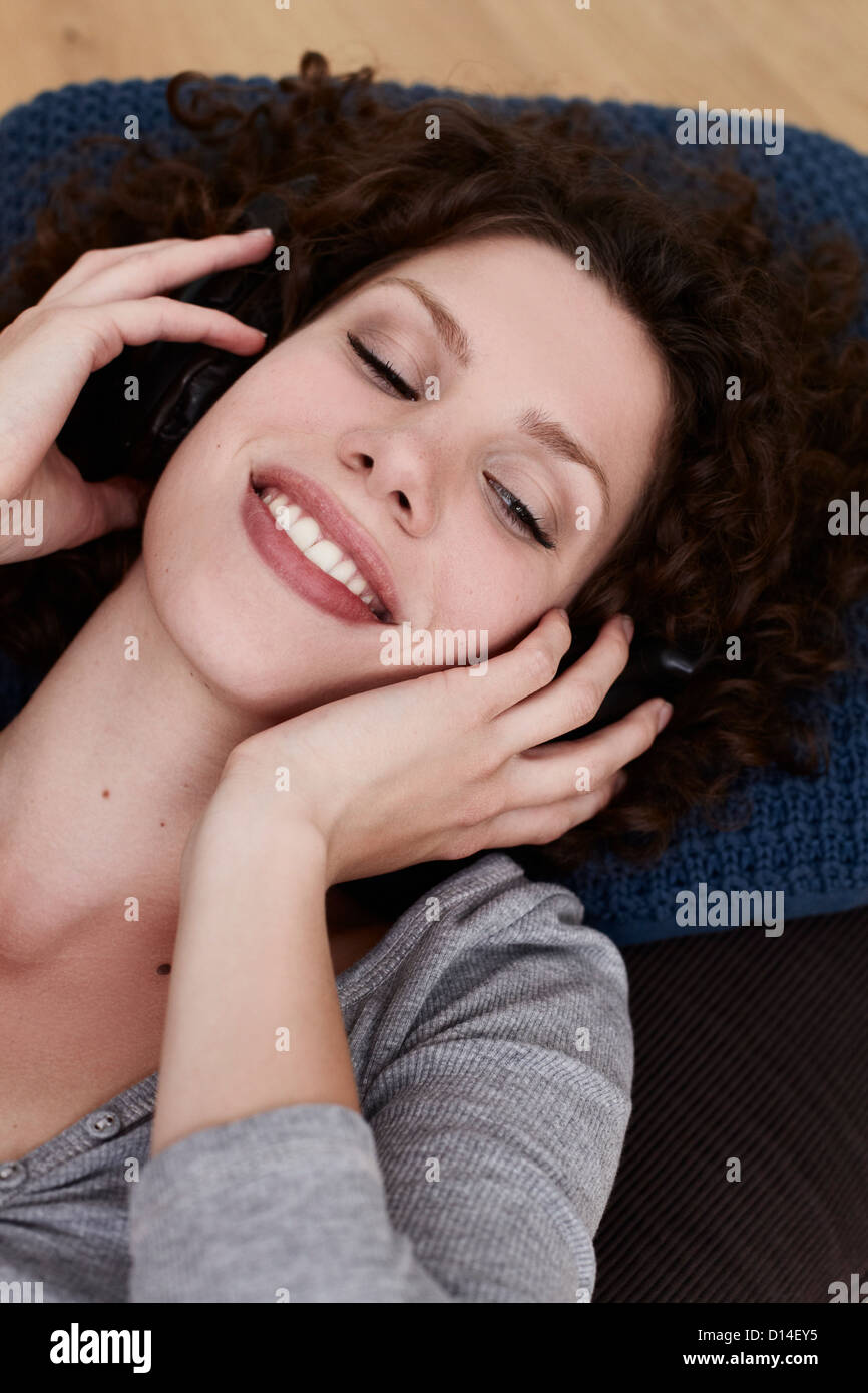 portrait of young woman listening to music Stock Photo