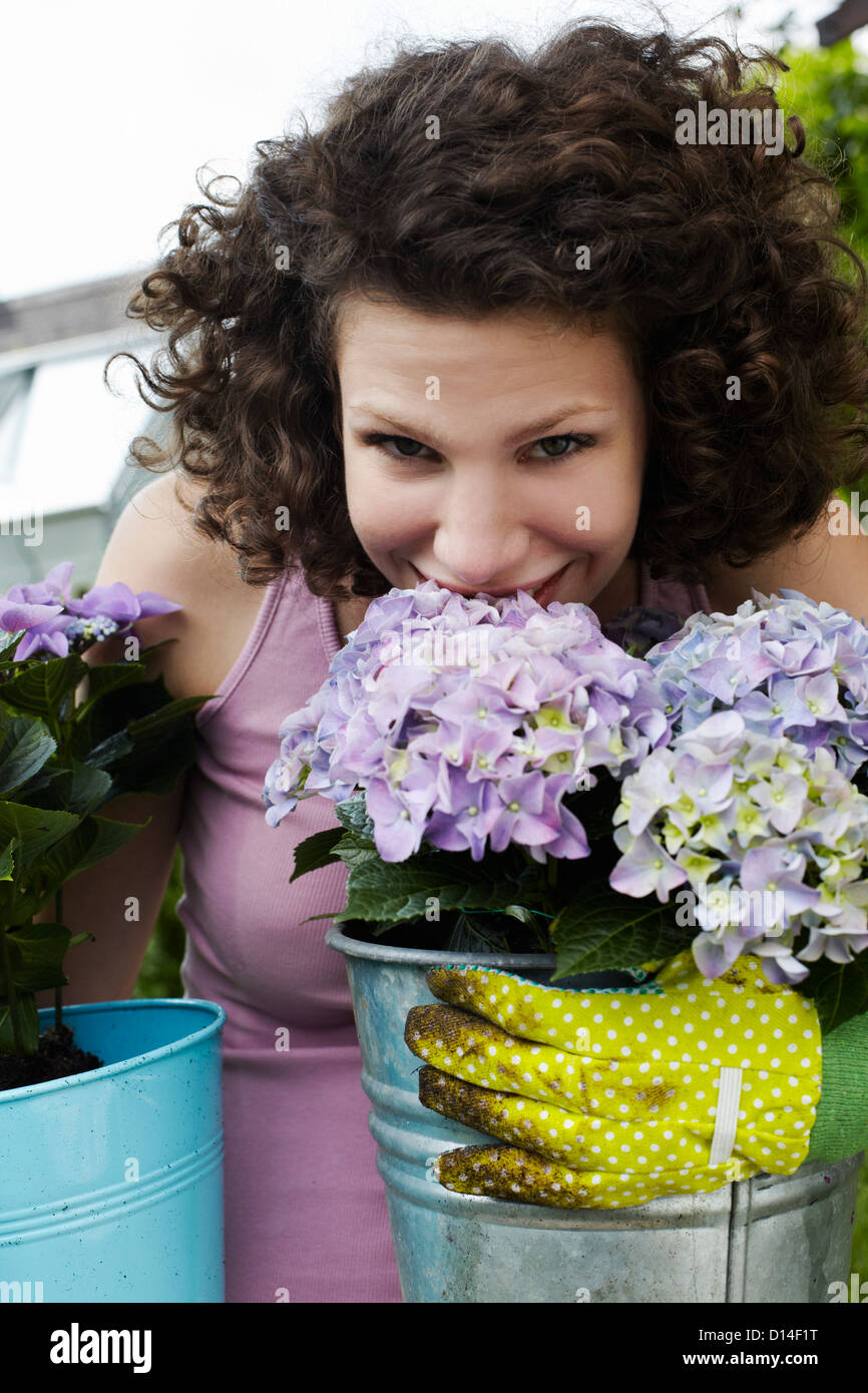 portrait of young woman smelling flowers Stock Photo