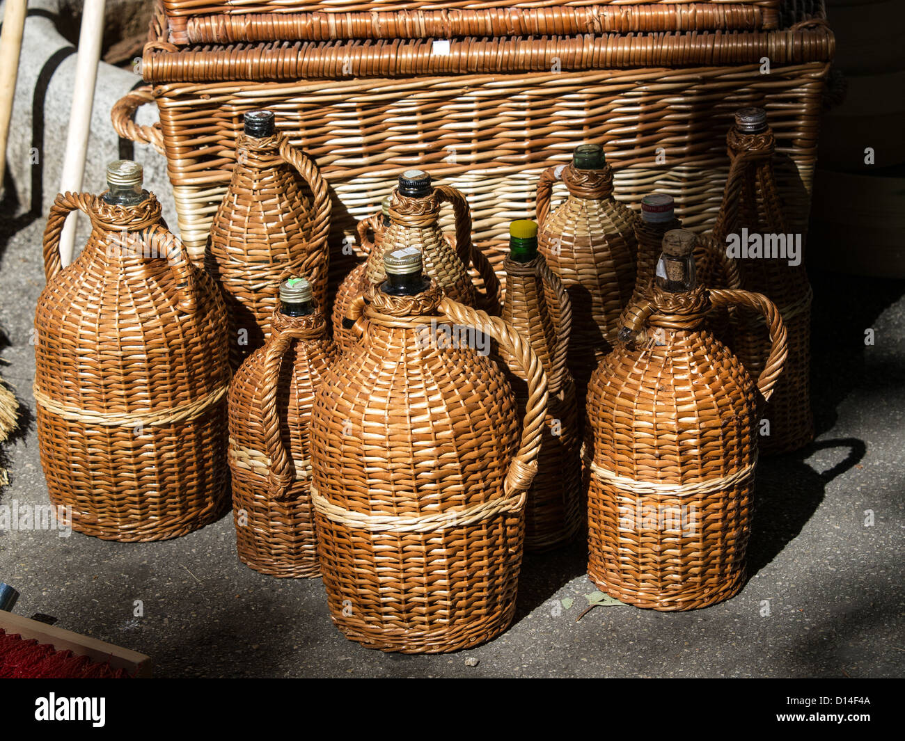 handmade bottles protected with cane Stock Photo
