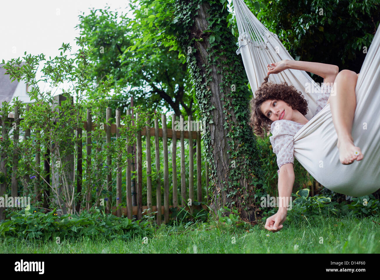 young woman lying in hammock in garden Stock Photo