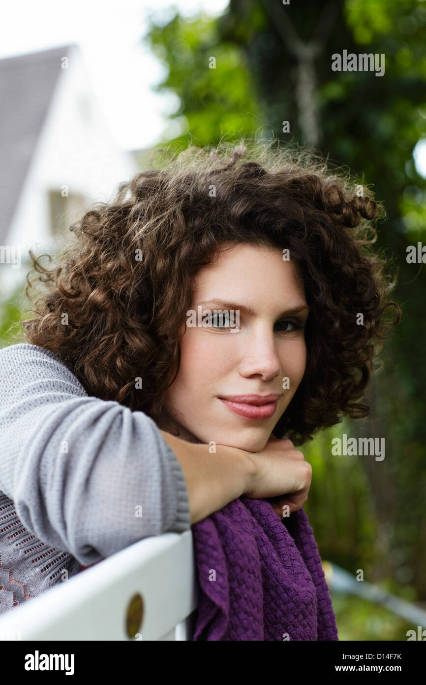 portrait of young woman sitting in garden Stock Photo