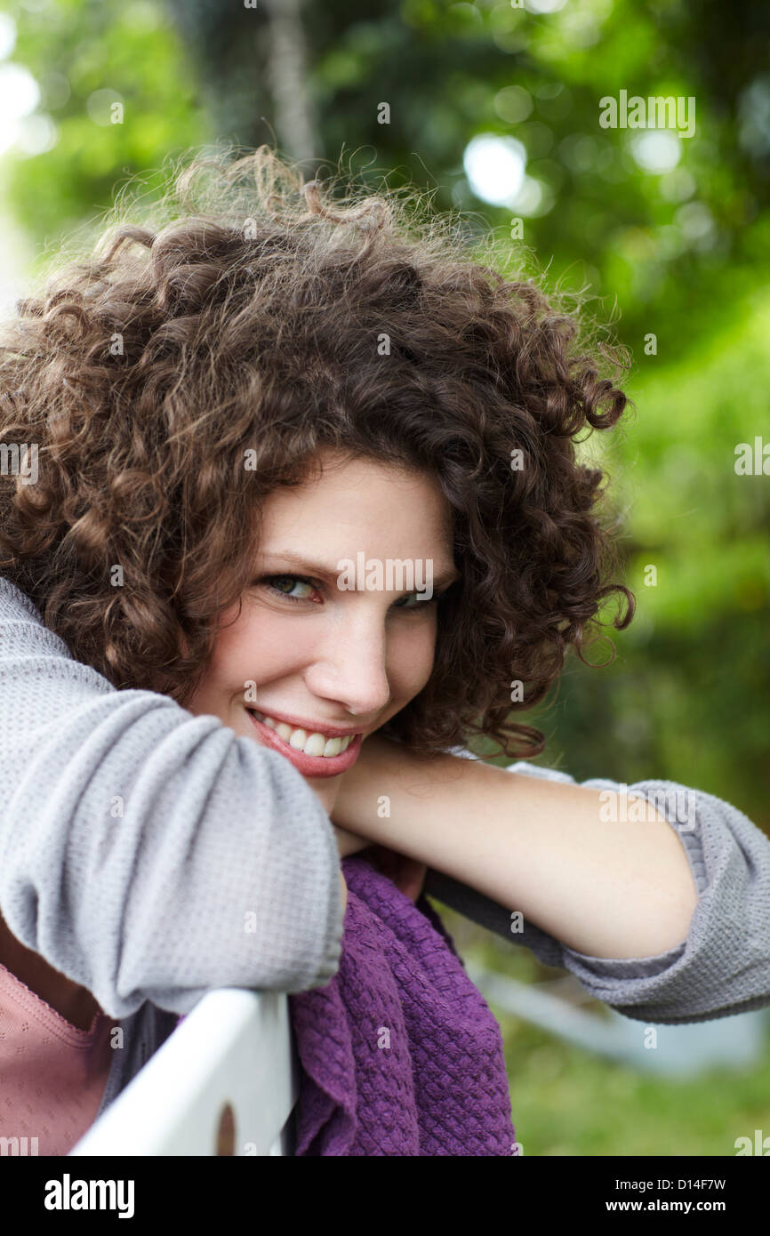 portrait of young woman sitting in garden Stock Photo