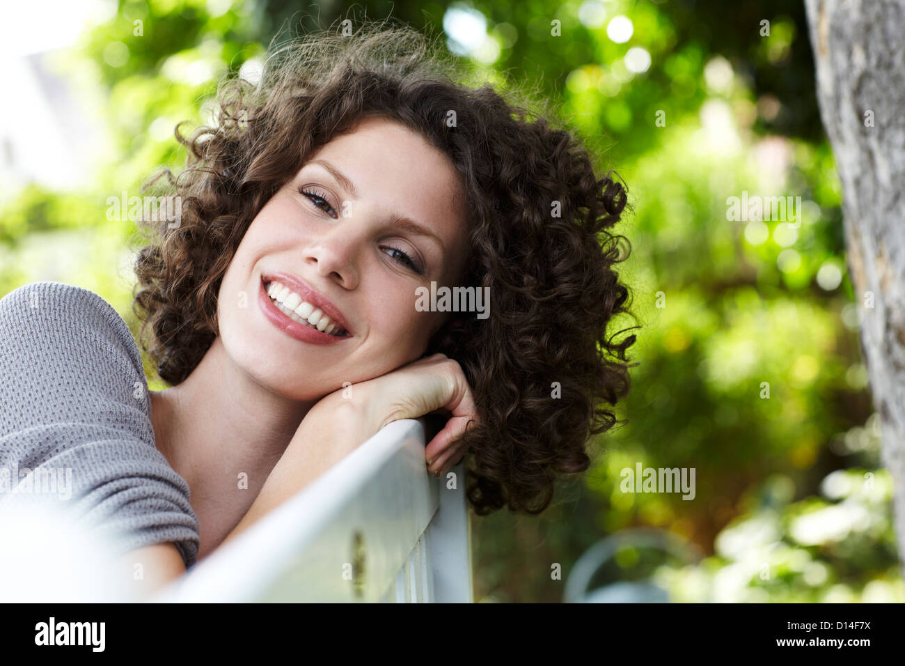 portrait of young woman sitting in garden Stock Photo
