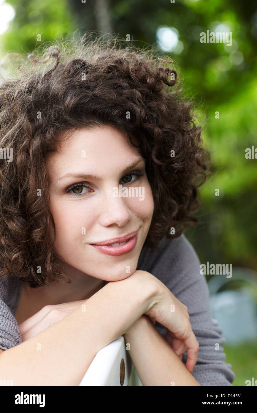 portrait of young woman sitting in garden Stock Photo