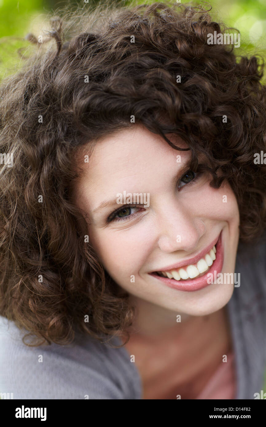 portrait of young woman sitting in garden Stock Photo