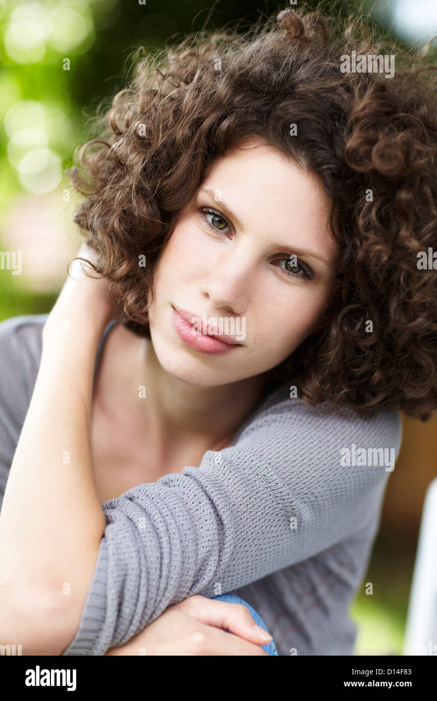 portrait of young woman sitting in garden Stock Photo