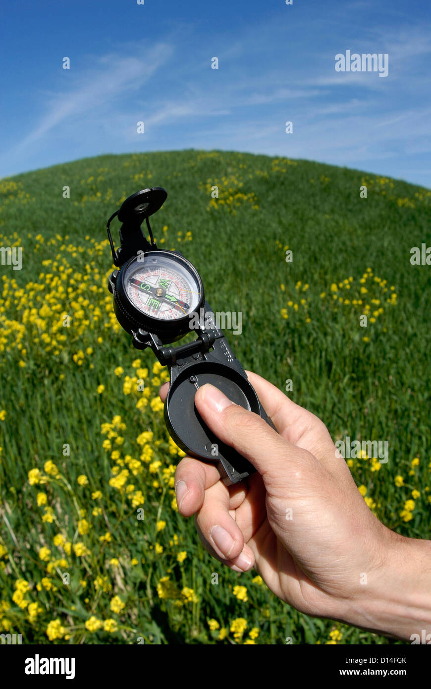 Man's hand holding compass Stock Photo