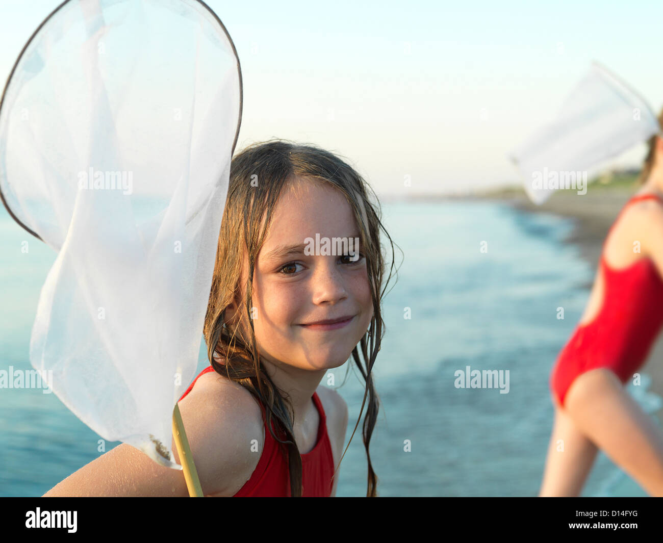 Girls fishing in shallow water Stock Photo