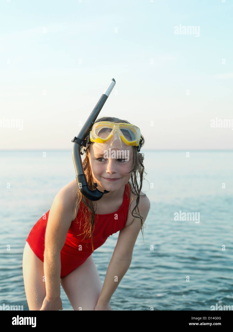 Girl wearing snorkel and mask in water Stock Photo