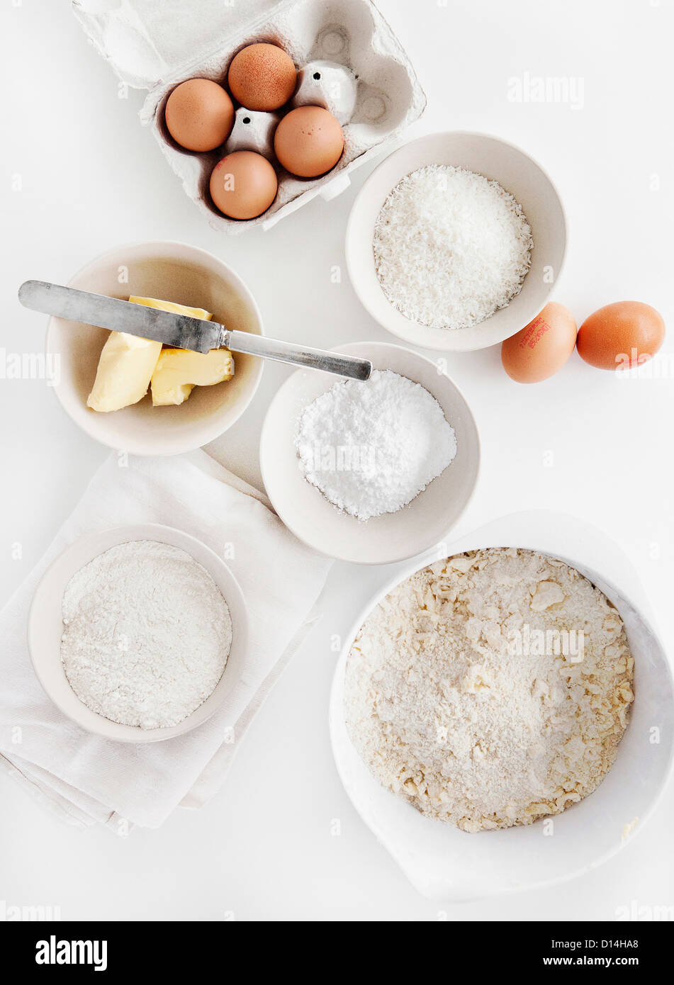 Bowls of sugar, flour, eggs, butter Stock Photo
