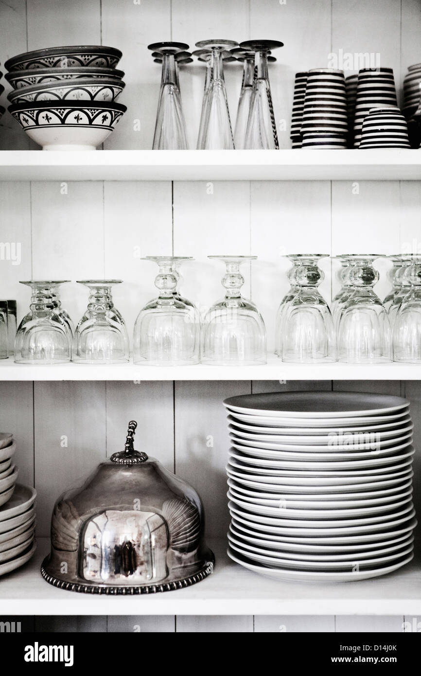 Shelves with glasses, plates and bowls Stock Photo Alamy