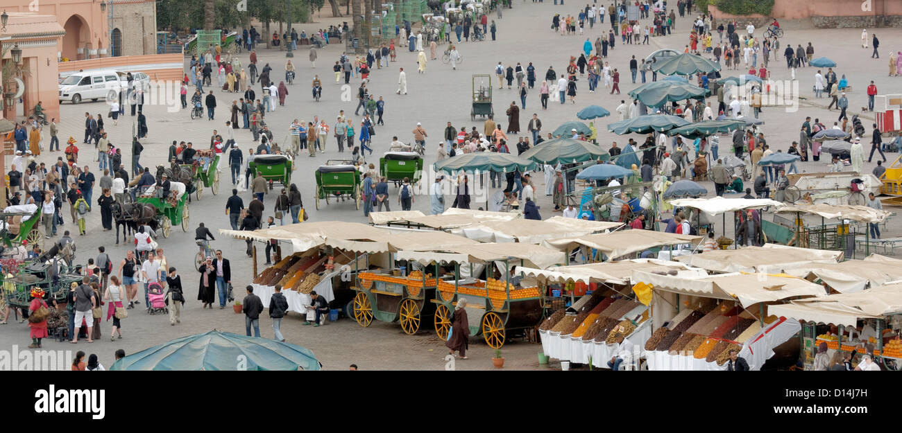 Crowds, food stalls and shops in Djemaa El Fna square, Marrakech, Morocco. Stock Photo