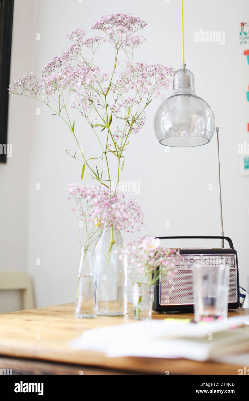 Flowers, radio and water glass on table Stock Photo Alamy
