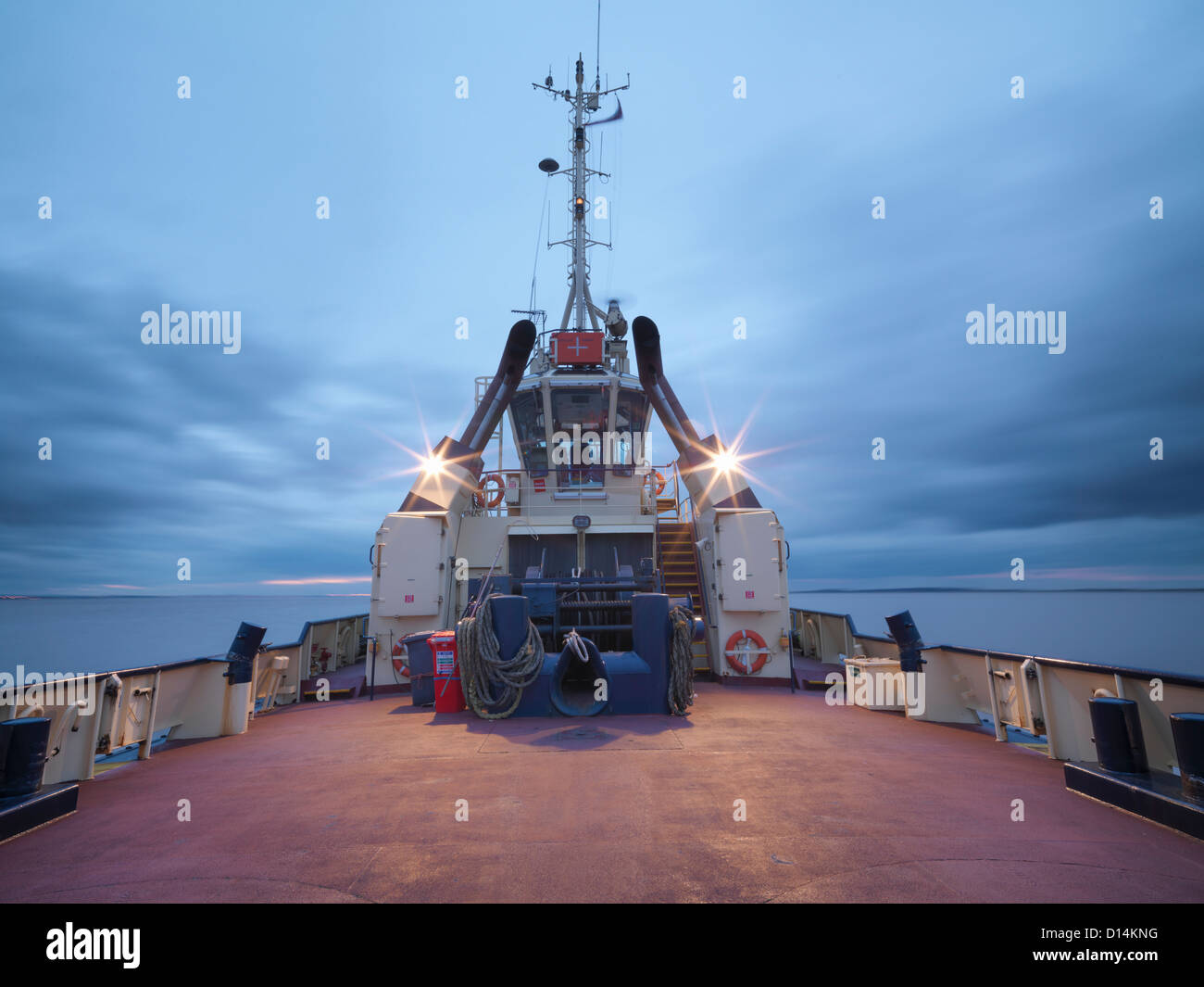 Tugboat deck lit up at night Stock Photo