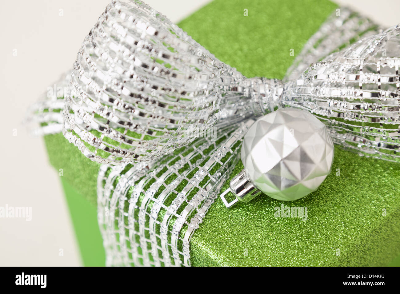 Close-up of green gift with christmas bulb Stock Photo