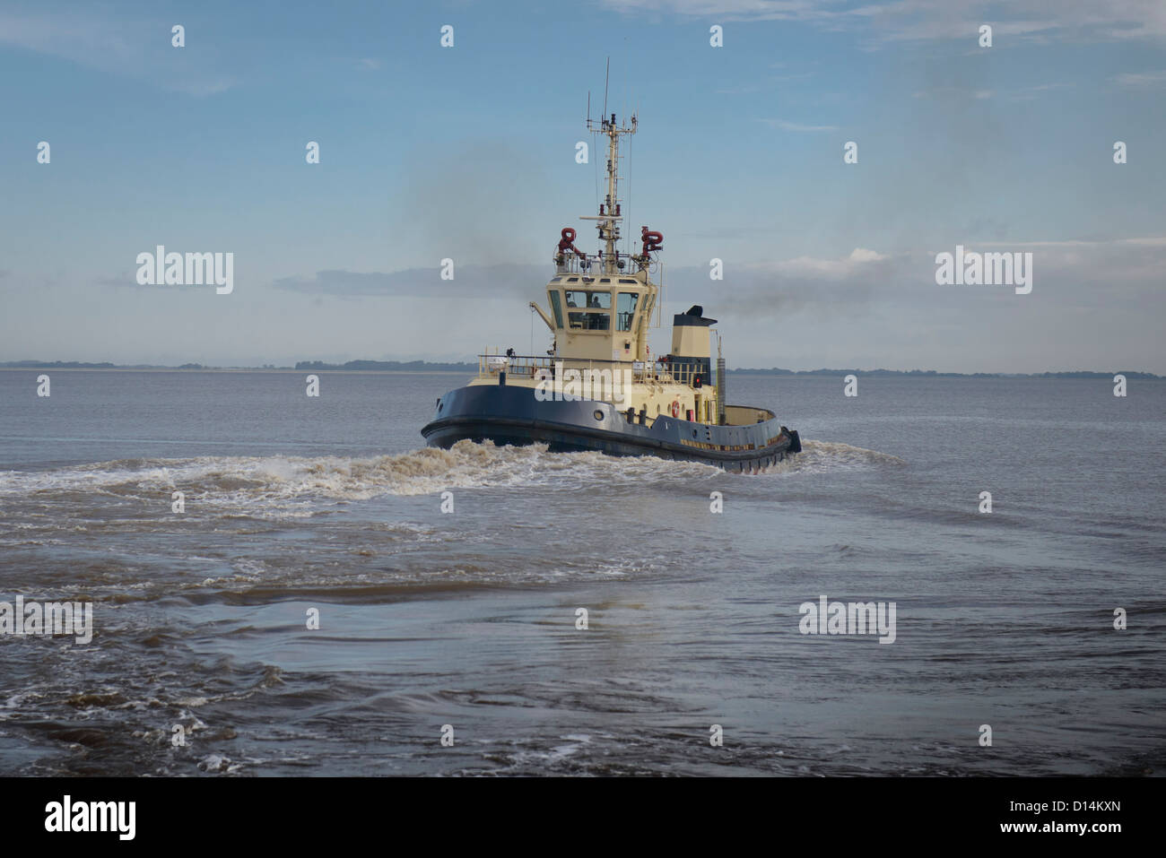 Tugboat sailing in water Stock Photo