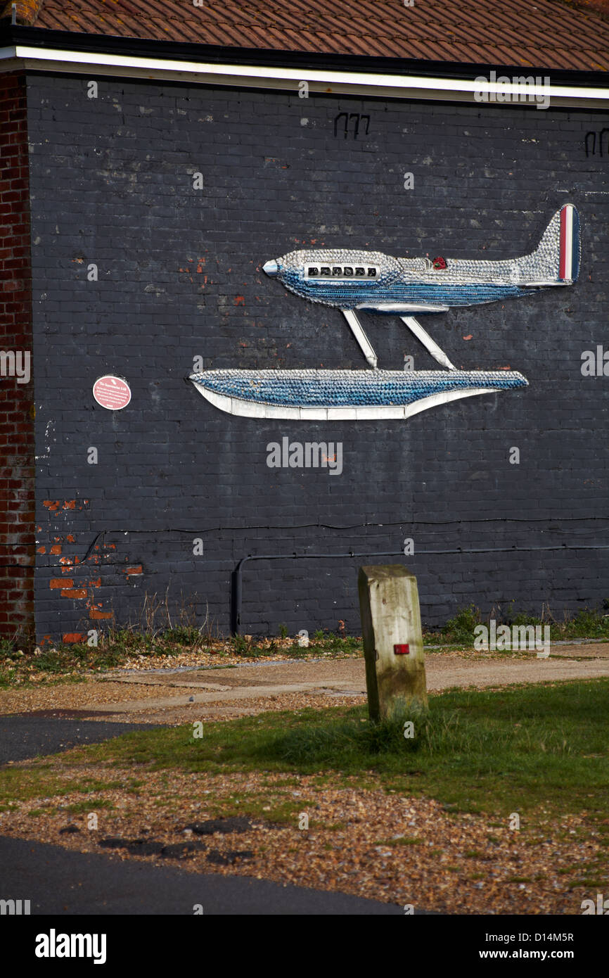 Supermarine S.6B decorative plane made of sea shells on side of building at Calshot, Hampshire in November Stock Photo