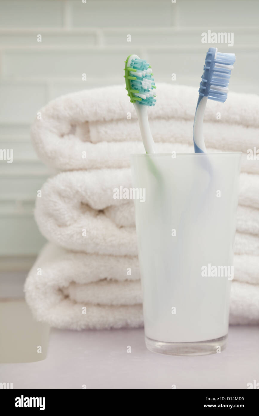 USA, Illinois, Metamora, stack of towels and toothbrush in holder Stock Photo