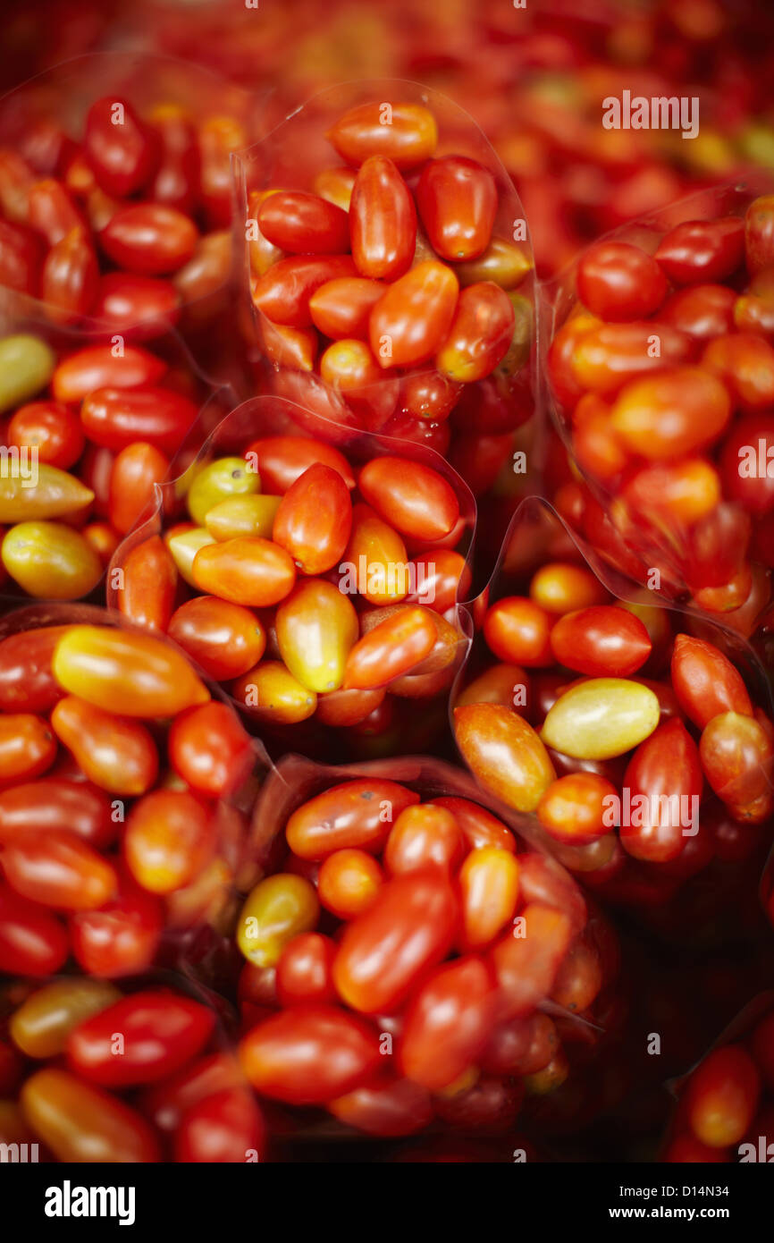 Bags of cherry tomatoes at market Stock Photo