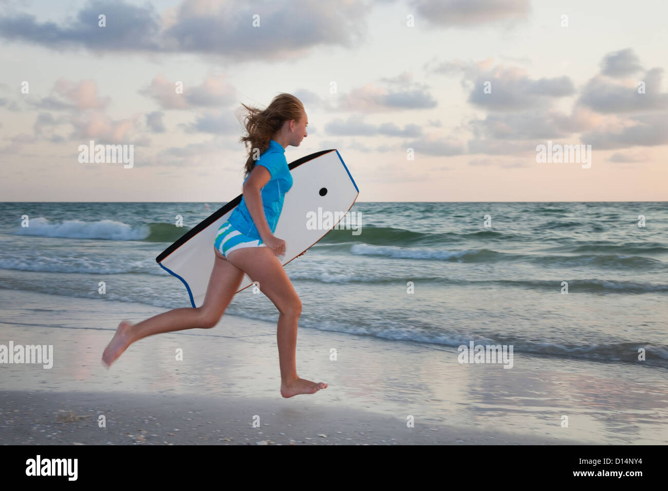 USA, Florida, St. Petersburg, girl (12-13) holding boogie board and looking at view Stock Photo
