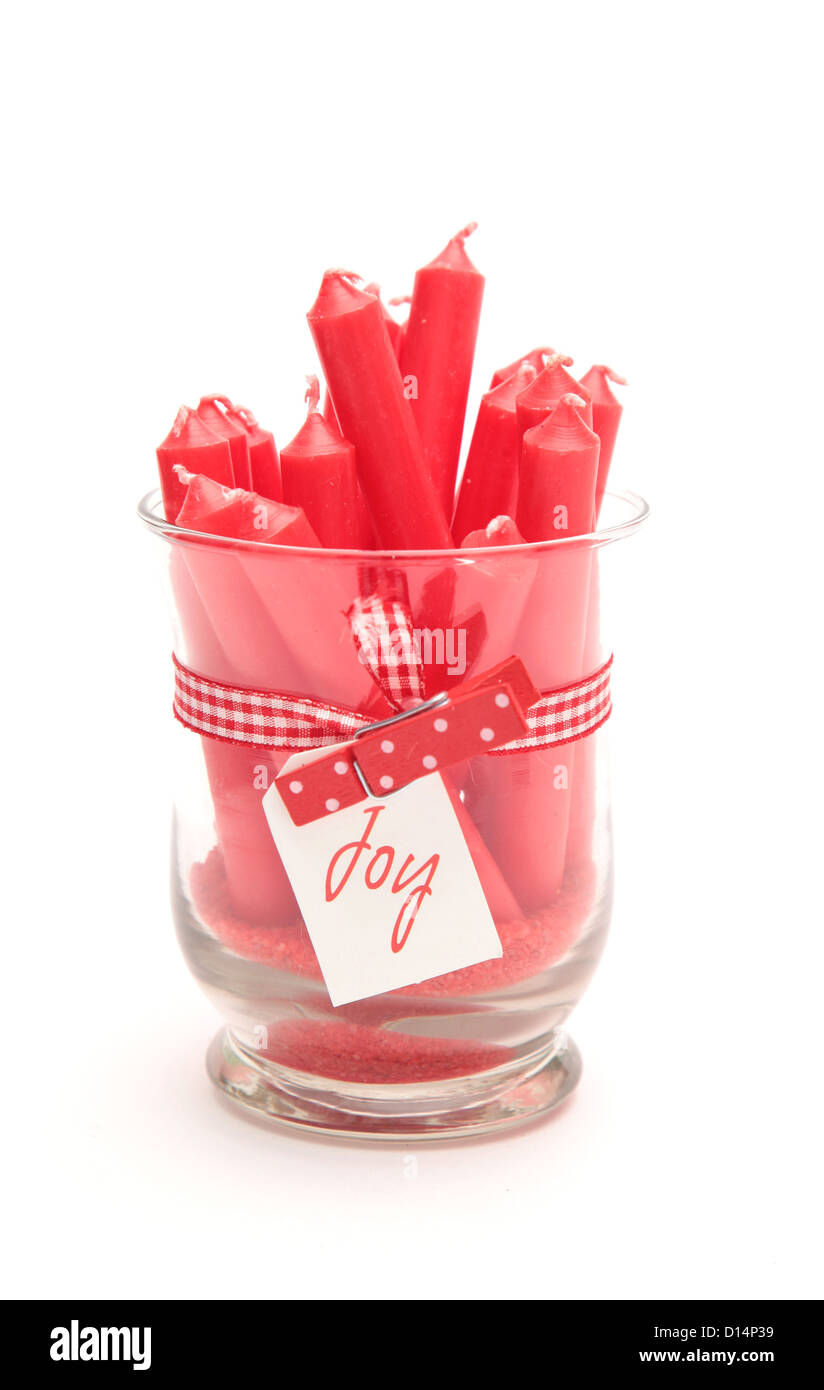 A glass filled with red candles for christmas Stock Photo