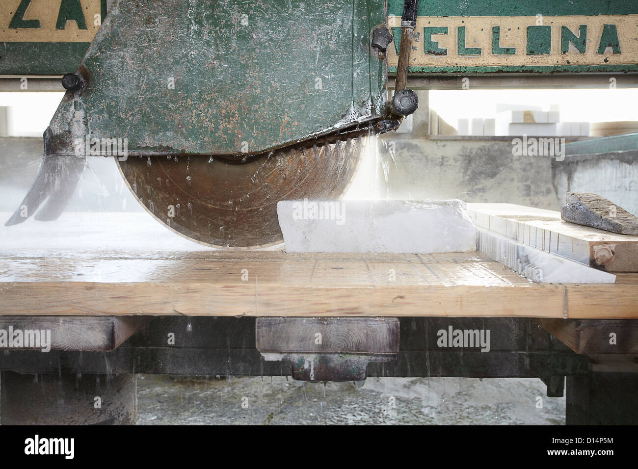 Machinery cutting stone on board Stock Photo