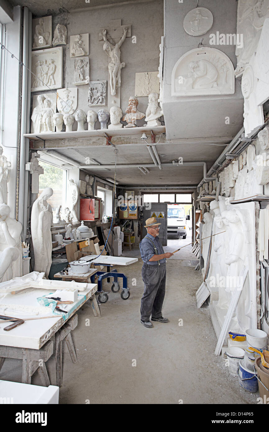 Worker standing in relief carving shop Stock Photo