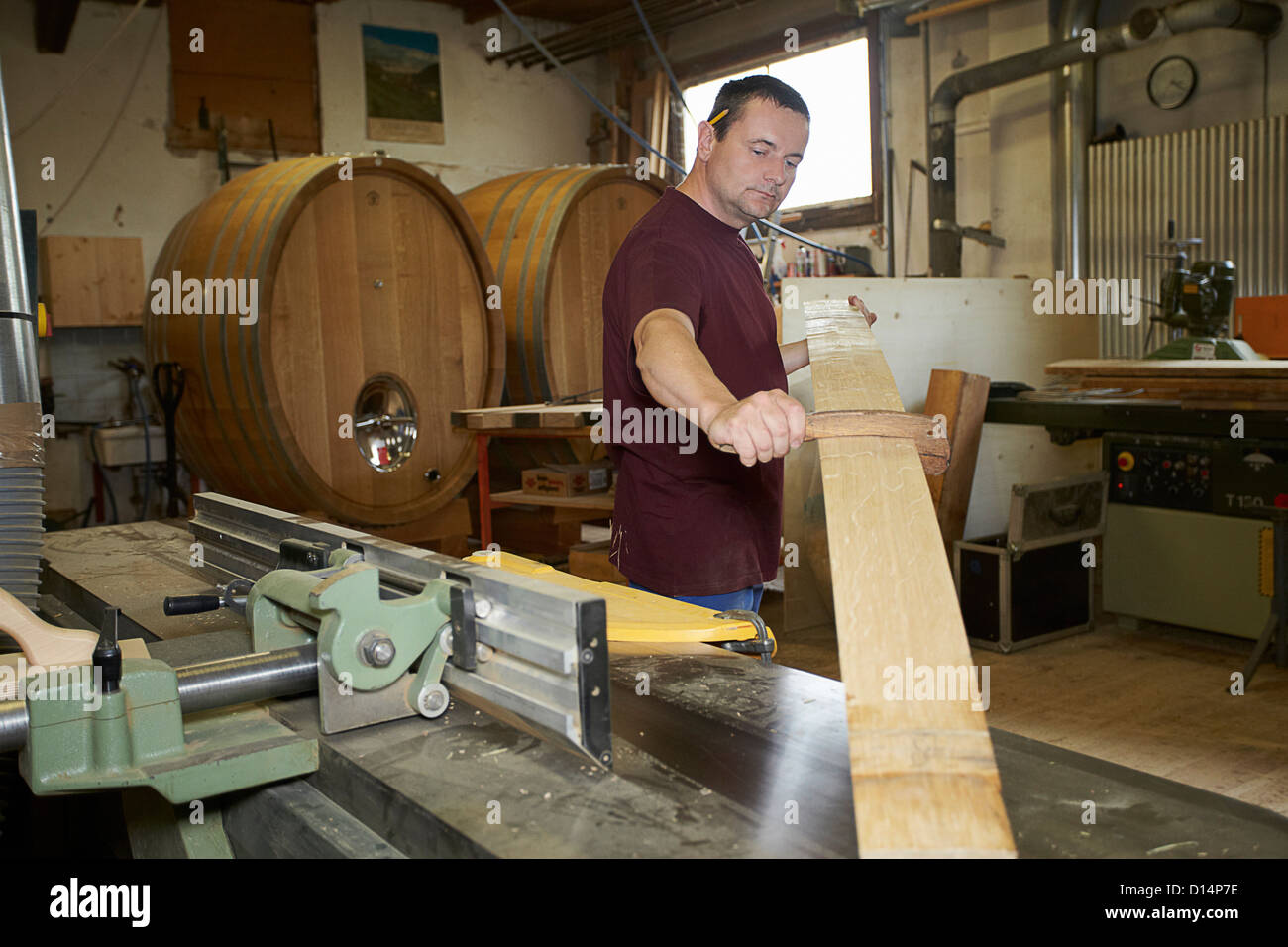 Worker examining wood in shop Stock Photo