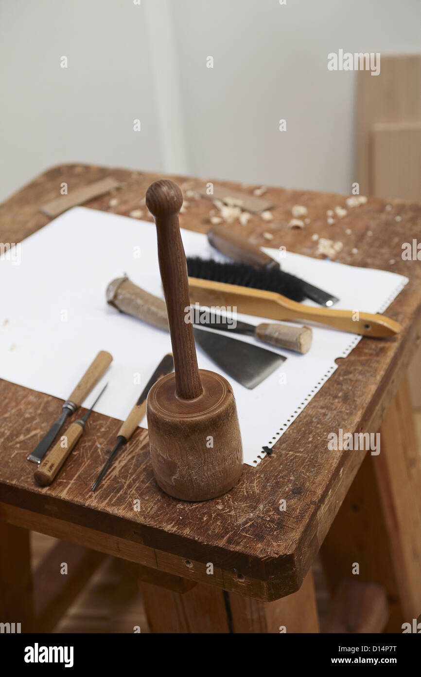 Chisel tools and paper on wooden board Stock Photo