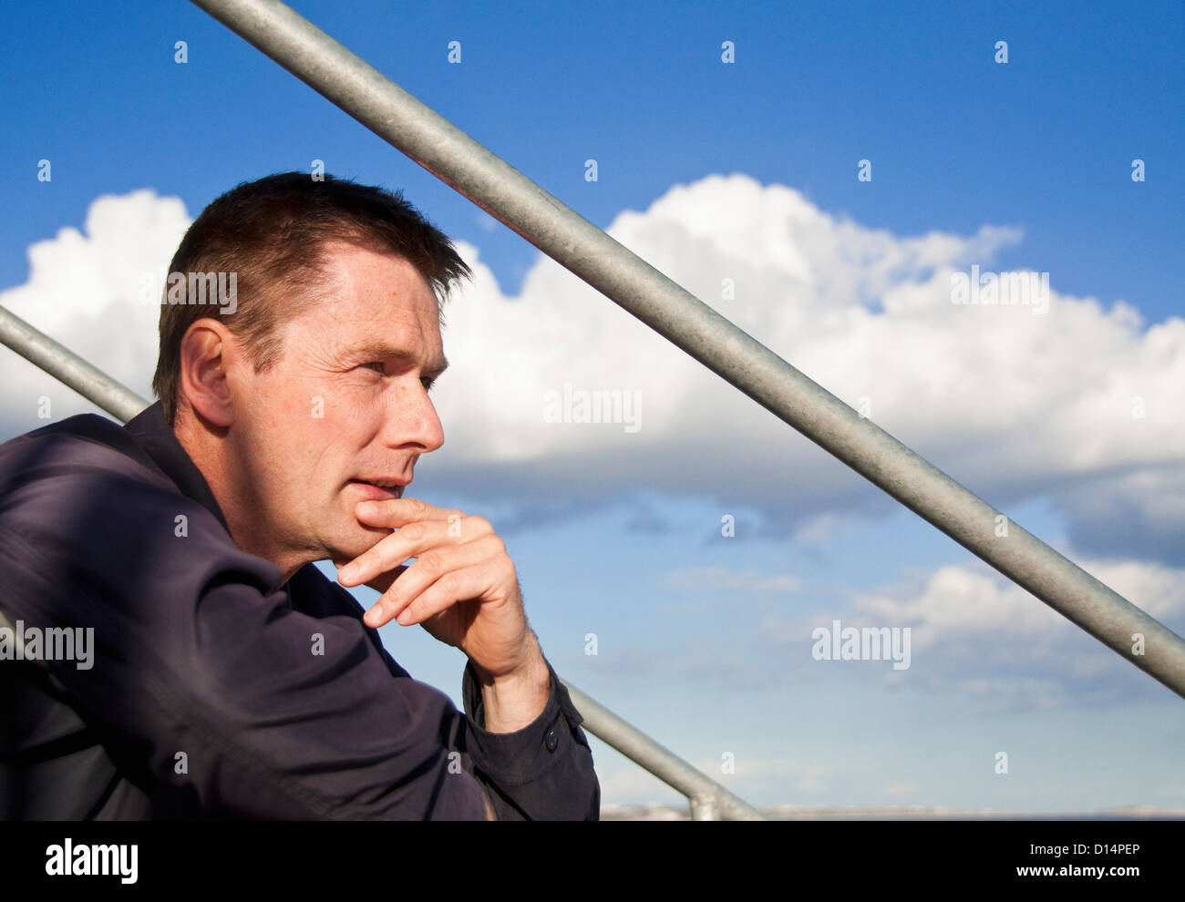 Man sitting on steps outdoors Stock Photo - Alamy