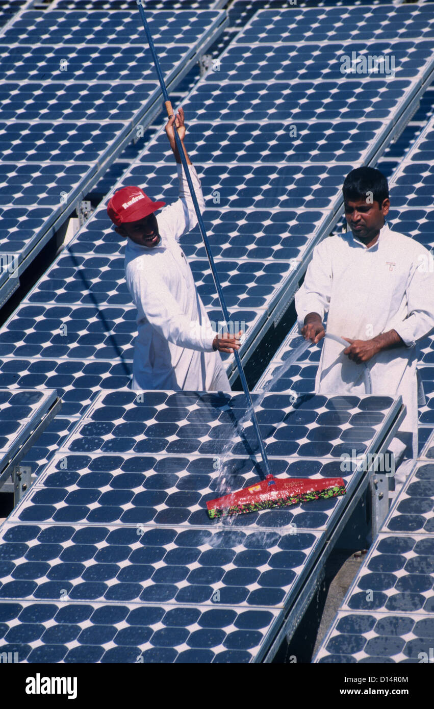 India Rajasthan, men clean solar panel in Brahma Kumari Ashram in Mt