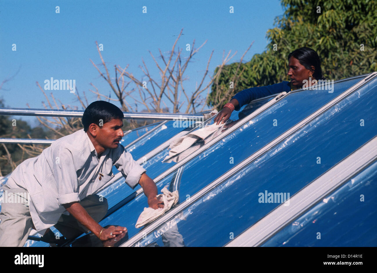 India Rajasthan, man clean solar collector in Brahma Kumari Ashram in Mt. Abu, solar collector is used to get heated water Stock Photo