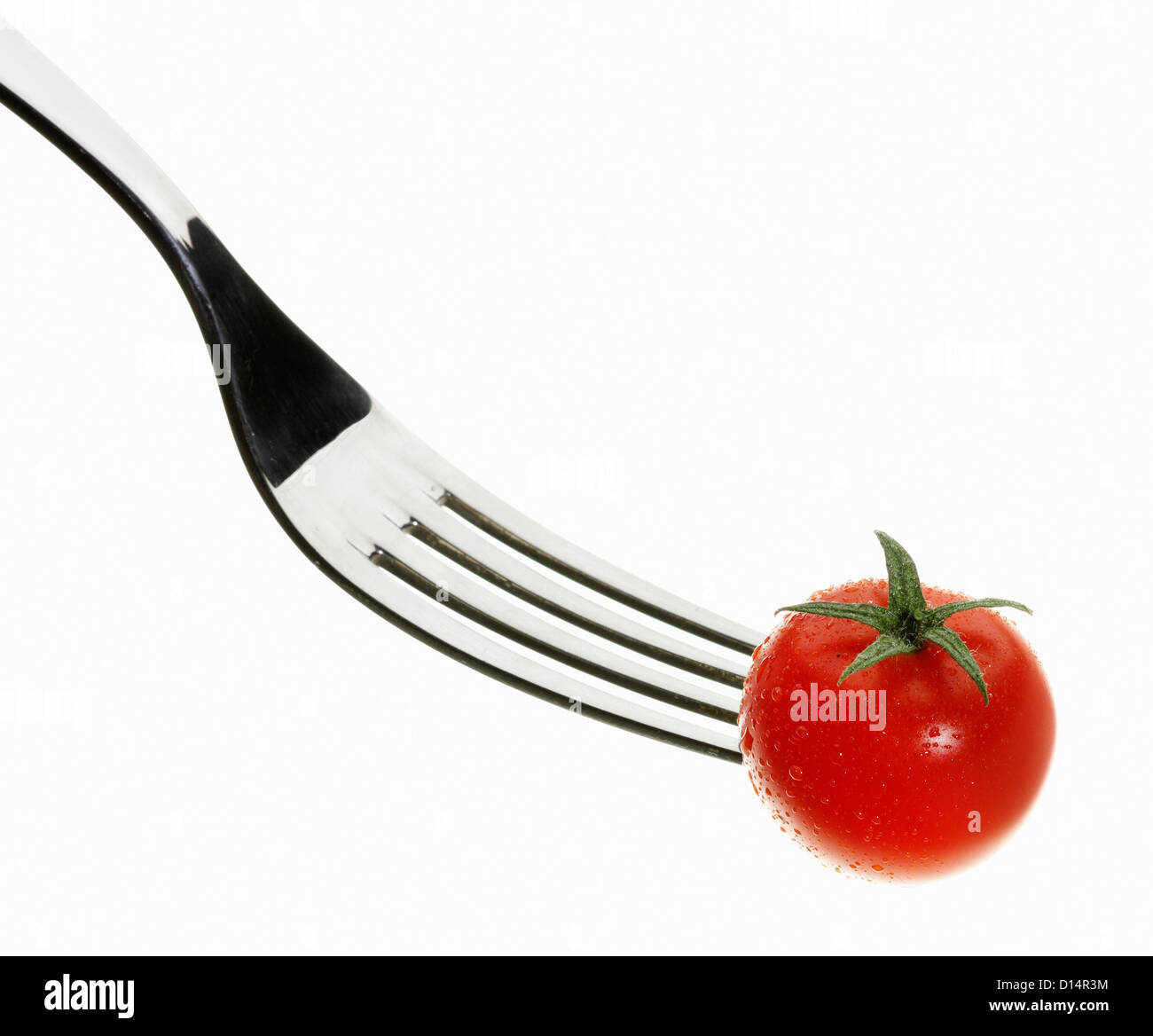 Close up of cherry tomato on fork Stock Photo